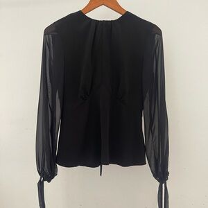 Black women’s blouse with sheer sleeves by Topshop.